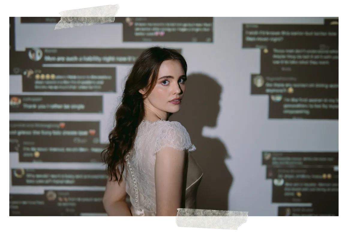 A woman in a white lace top looking back over her shoulder, a wall of projected chat messages behind her