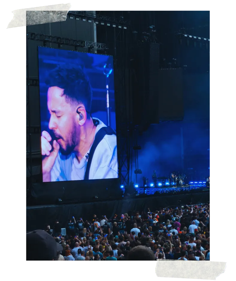 The stage screen carrying a vocalist in close-up under blue light