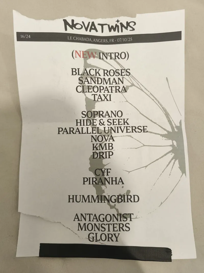 The handwritten setlist taped down at the edge of the stage — NOVATWINS, Le Chabada, Angers, with the running order scrawled below